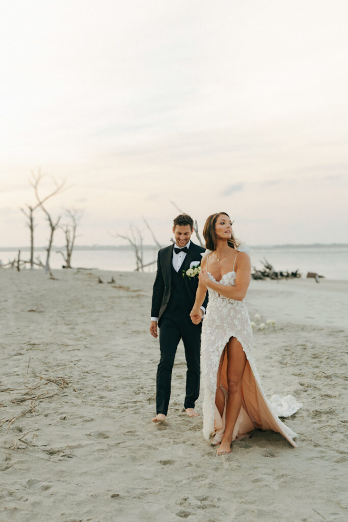 One of the best things to do when you elope is to choose a location you love - like this couple walking on the beach.