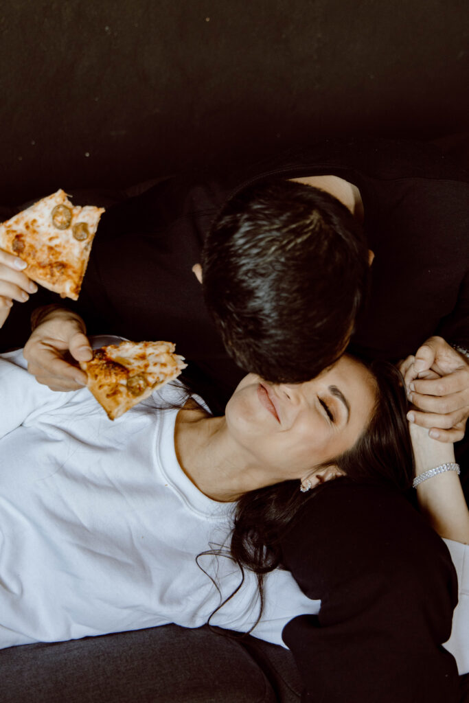 A couple enjoying pizza together on the day of their elopement - a great example of what to do when you elope!